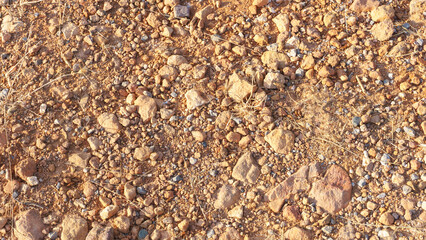 Dry, rocky terrain with small pebbles and earth, ideal for nature, background, or texture projects.
