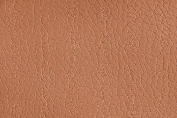 Texture of genuine leather or artificial synthetic leatherette orange color background