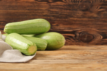 Fresh green zucchini on wooden background