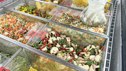 Selling frozen vegetables in the fridge of a grocery store.