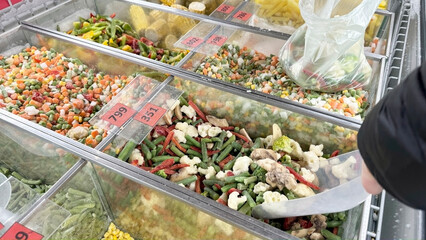 Selling frozen vegetables in the fridge of a grocery store.