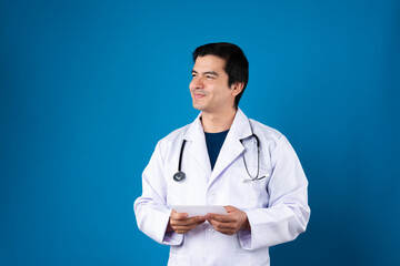 Portrait of thinking smart doctor holding transparent tablet while looking research data futuristic technology for remedy therapy healthcare innovation interface hologram monitor screen. Contrivance.