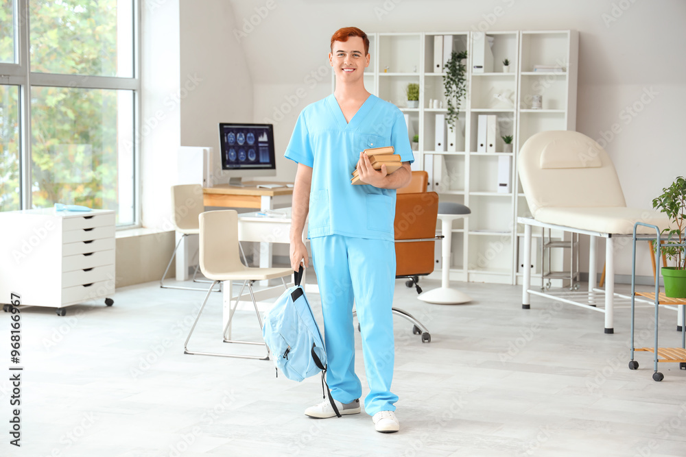 Wall mural male medical student with books in clinic