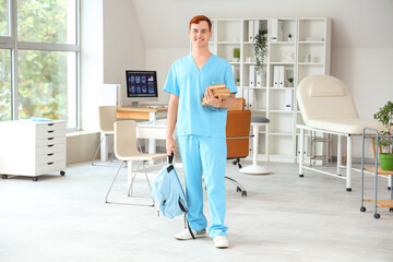 Male medical student with books in clinic