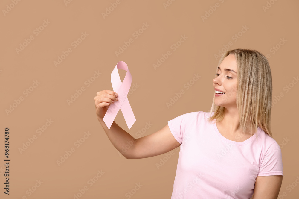 Poster Young woman with pink ribbon on beige background. Breast cancer awareness concept