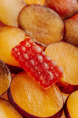 Natural plum marmalade on fresh sliced plums, vibrant color and texture for food advertising