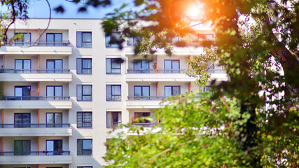 Obraz premium European residential architecture harmonizing with nature. Eco-friendly living in city with greens. Eco apartment building saving energy and fresh air concept. 