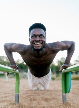 Man performing calisthenics at outdoor fitness park