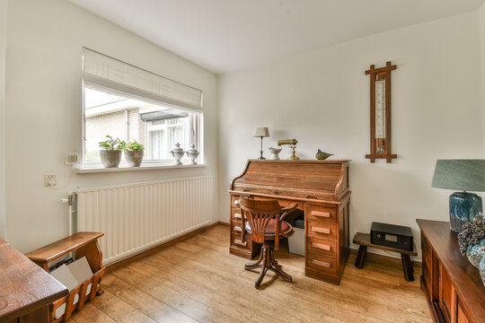 Cozy home office with vintage wooden desk and chair