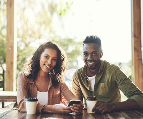 African couple, smile and restaurant with phone for communication and conversation with drink. Woman, man and interracial relationship with smartphone on coffee shop date with happy bonding portrait