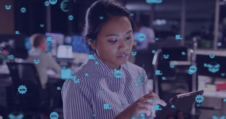 Animation of network of connections with icons over biracial businesswoman using tablet in office - Powered by Adobe