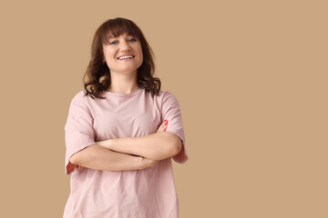Fototapeta premium Beautiful woman smiling on beige background