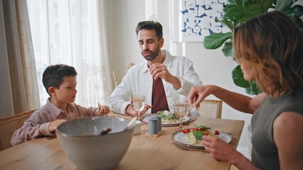 People having family breakfast at kitchen table closeup. Parents child eating