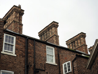 row of large tall chimneys on old brick houses in Chester England