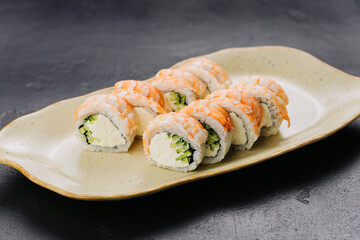 Shrimp sushi rolls Philadelphia with creamy filling and cucumber, Japanese cuisine themes