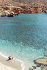 Person reading a book on the beach, Folegandros, Greece