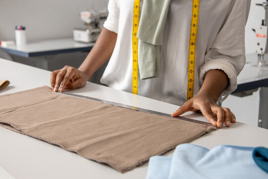 Woman designer working on fashionable couture handling beautiful fabrics