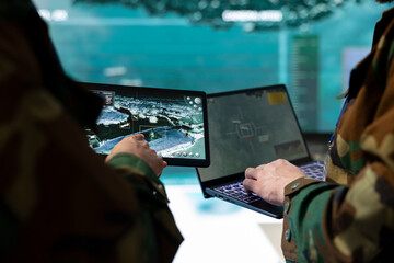 Troopers comparing gathered radar information on laptop and tablet, communicating with allied...