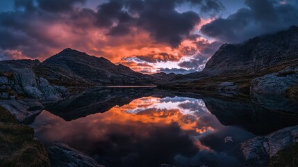 A beautiful sunset over a lake with mountains in the background