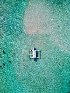 Drone view of a boat on a sandbar in Balabac, Philipinnes