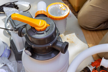 Assembling sand filter system tank using equipment that is used to clean pools swimming pool