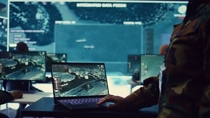 Navy operations specialist examines ships along the coast line to ensure national safety, employing...