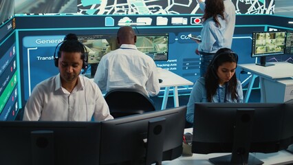 Indian woman dispatch operator gives directions to couriers, avoiding traffic by monitoring radar...