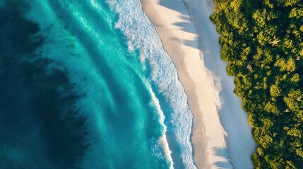 A drone shot of a pristine coastline with turquoise ocean water and white sand beaches.