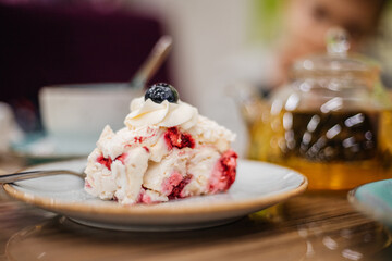 Beautiful delicious cake decorated with blueberries in a cafe - close-up