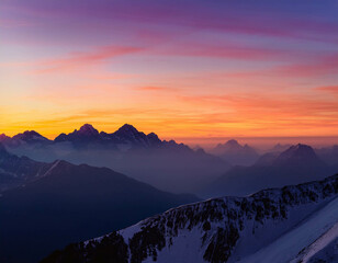 Obraz premium A breathtaking view of a mountain range at sunset, with the sky painted in shades of orange,
