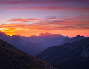 Fototapeta premium A breathtaking view of a mountain range at sunset, with the sky painted in shades of orange,