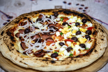 Traditional Brazilian pizza, half pepperoni with onions and half Portuguese