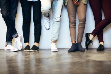 Legs, waiting room and group of people for recruitment, hiring and work opportunity on wall background. Shoes, candidates and audition with onboarding for job interview, internship or human resources