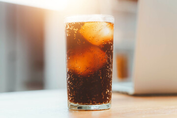 Glass of cola, Double cool ice soft drink cola carbonated liquid fresh food with soda water, Cola drinking with ice in glass ready to refresh you, A cola soft drink is placed on the desk.