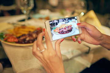 Hand, woman and smartphone screen for food photography on dinner in table at restaurant for social...