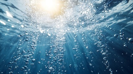 Fototapeta premium Underwater Sunlight and Air Bubbles Rising in Blue Water