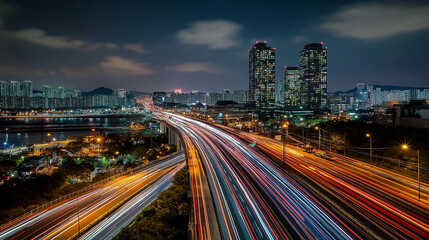 Fototapeta premium Highway traffic leading to modern city skyline at night