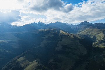 Aerial view of woman trail runner in high altitude mountains