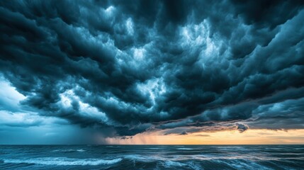 A stormy sky with dark clouds and a bright orange sun in the background