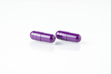 Two medicine capsule pills, supplement isolated on with background
