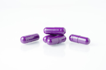 Pile of medical capsule pills, supplement vitamin, isolated over the white background