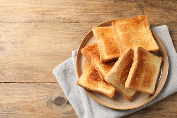 Delicious toasts on wooden table, top view. Space for text