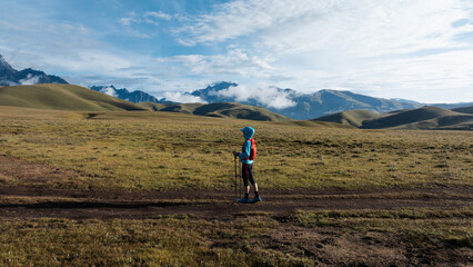 Aerial view of woman trail runner in high altitude mountains