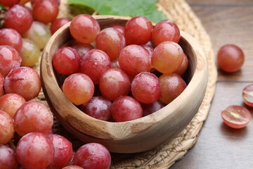 Fresh ripe grapes on wooden table, closeup
