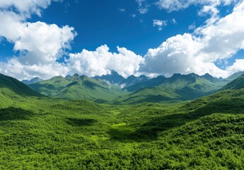 Naklejka premium Lush green mountain landscape with blue sky and clouds