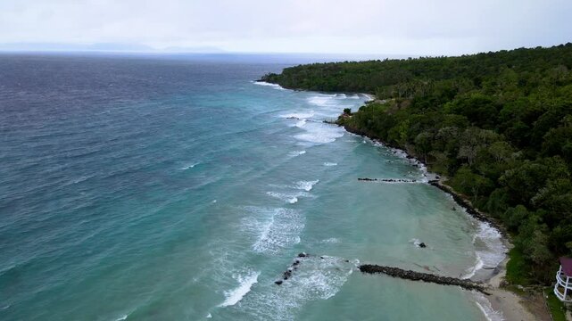 Aerial View of Seawater Crashing Along the Shoreline