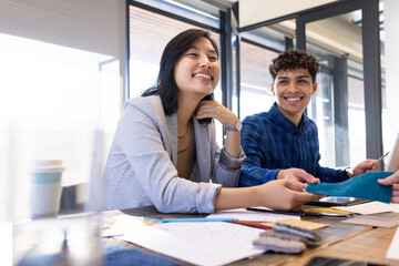 Diverse colleagues sharing fabric samples and ideas in office