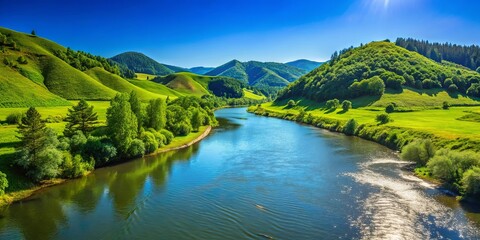 Fototapeta premium Beautiful river flowing amidst lush green hills under clear blue sky on a sunny day