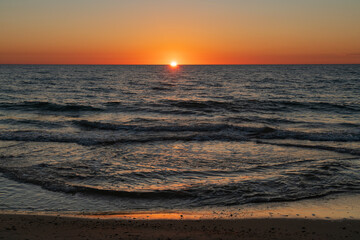 Incoming wave and setting sun over the Baltic Sea, Curonian Spit, Kaliningrad region, Russia
