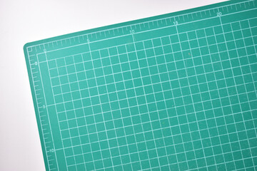 green cutting mat board on white background with line and scale measure guide pattern for object art design, tool equipment of diy craft work